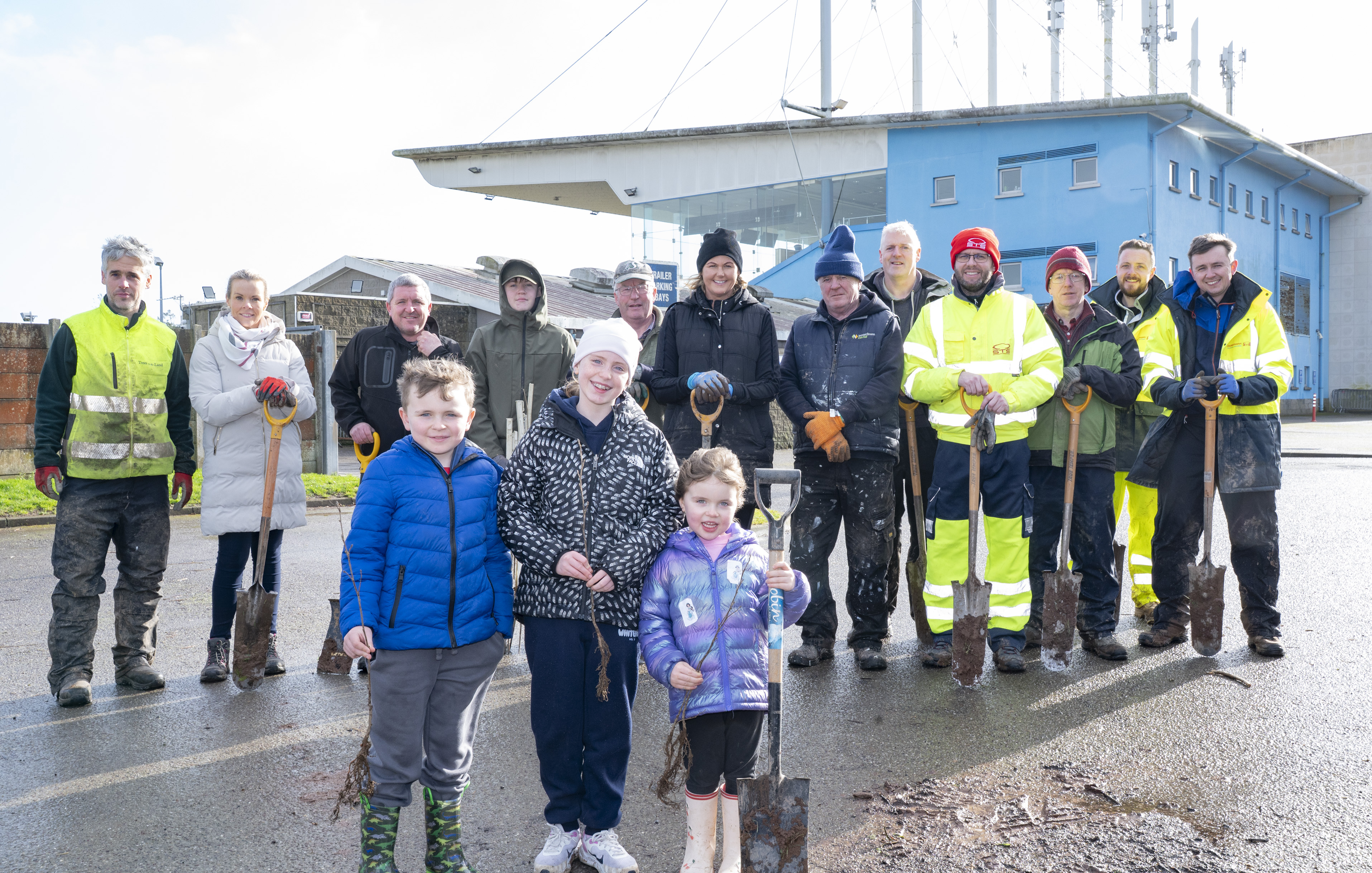 Volunteers, families, children, and representatives from STS Group Cork and Friends of Curraheen Park gather together at the stadium during the large-scale planting of native Irish trees.