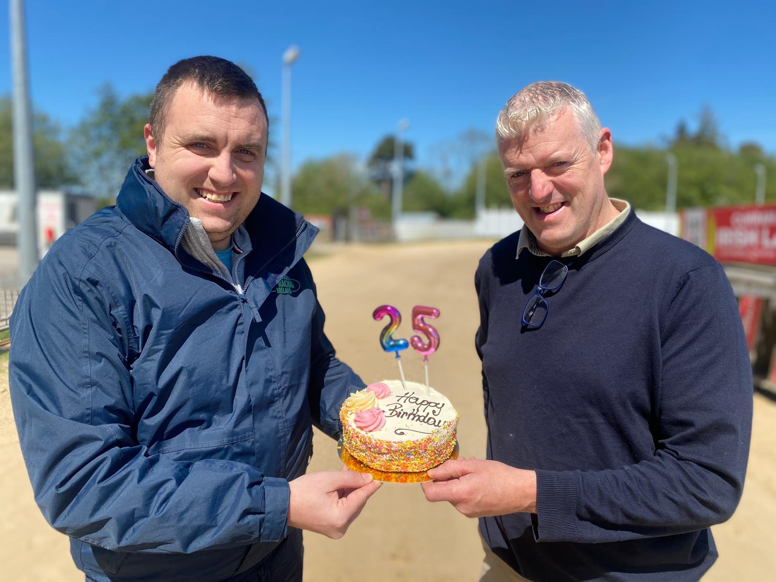 Brian and Darren with cake to celebrate launch of 25th anniversay at curraheen park