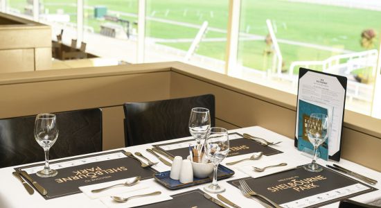 Enjoy a delicious meal in Dublin's Shelbourne Park Greyhound Stadium with a newly revamped restaurant offering top-quality food and service and allowing you to view the racing both outside the window and through TV screens located throughout the restaurant Image shows a table set for dinner service in Shelbourne Park Greyhound Stadium's restaurant overlooking the racecourse in Dublin