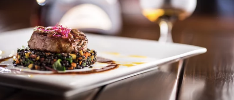 Enjoy a delicious meal in Dublin's Shelbourne Park with action-packed raing outside Image shows a plate of food