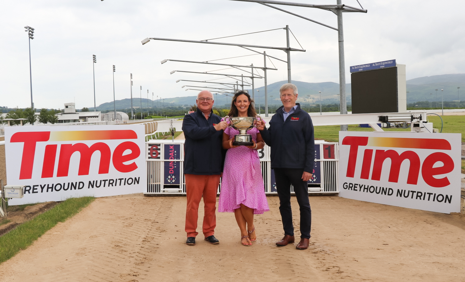 Lisa O’Connor, Sales & Marketing Manager Dundalk Stadium holds the Dundalk International Trophy in between John Fox & Wille Rigney of Time Greyhound Nutrition.